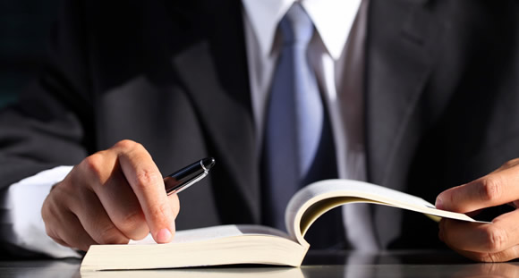 Two Businessmen Reviewing Documents at a table.